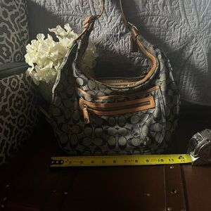 Coach signature canvas hobo shoulder bag with tan leather trim.